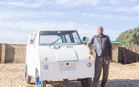 Samuel Njogu poses with his locally assembled tuk-tuk in Nyahururu town.