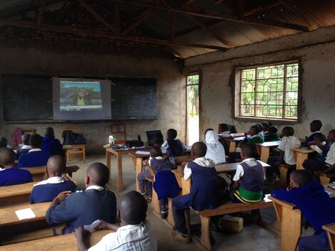 School children watching a TV programme in a classroom in November 2021.