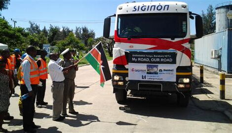 AnSigiono Group lorry being flagged off before the start of a journey.