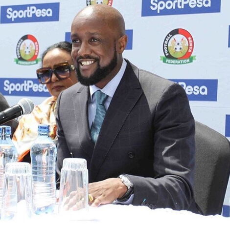 Sportpesa CEO Ronald karauri in one of Narok NYC's designs addresses the press in June 2019. On his left is Sports CS Amina Mohammed.