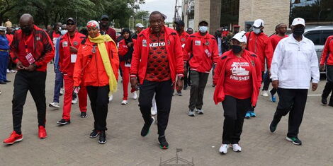 Sports CS Amina Mohamed ( in yellow scarf), President Uhuru Kenyatta (centre) and First Lady Margaret Kenyatta (second right) arrive at the Nyayo National Stadium for the inaugural Nairobi City Marathon on May.