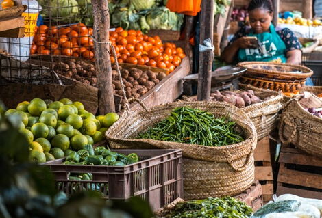Undated image of a lady selling vegetables at a local fresh produce market.