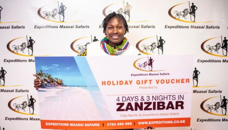 The dancing nurse Lokresia Karema with a 4-day trip to Zanzibar gift voucher after signing deal on Thursday, November 10, 2022.