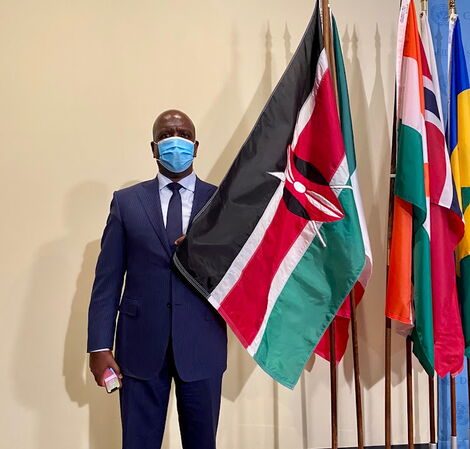 The Permanent Representative of Kenya to the United Nations, Martin Kimani, posing with Kenyan flag