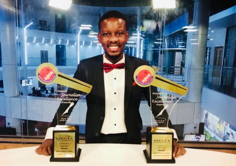 Timothy Otieno Poses for a Photo With His Awards.