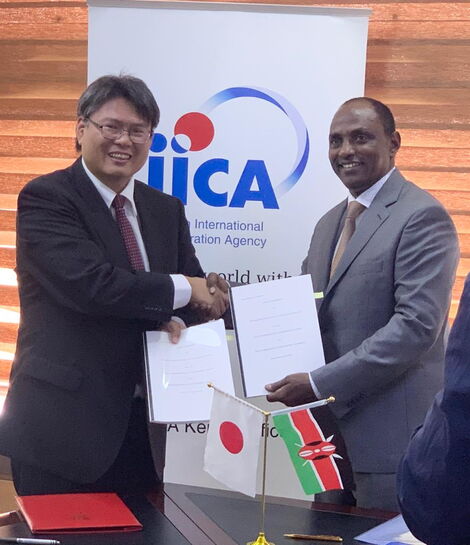 Treasury CS Ukur Yattani (right) with a representative of the Japanese government pose for a photo after agreeing on a loan deal at the Treasury Buildings on February 27, 2020.