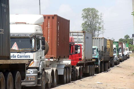 Trucks stopped at traffic jams along a highway.