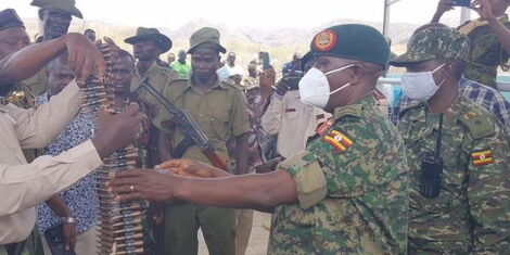 Kenyan officials handing over bullets to the Uganda delegation at a meeting on April 7, 2022.