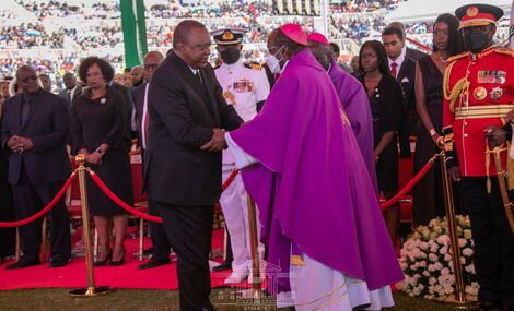 President Uhuru Kenyatta (left) greets Archbishop Philip Anyolo at the National Funeral Service of the late President Mwai Kibaki on Friday, April 29, 2022