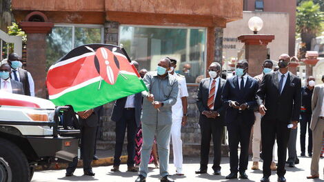 From left: President Uhuru Kenyatta flags of Nairobi Metropolitan Services (NMS) water trucks and ambulances at Harambee House as Nairobi Senator Johnson Sakaja and NMS General Mohamed Badi watch on Tuesday, June 30, 2020 