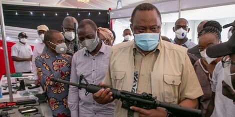 President Uhuru Kenyatta holding the Kenya-made CMZ 4 assault rifle at the KWS Law Enforcement Academy in Manyani, Taita Taveta County, October 16, 2020