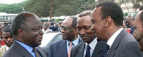 Former President Mwai Kibaki (left) with President Uhuru Kenyatta (right) in an event in 2010