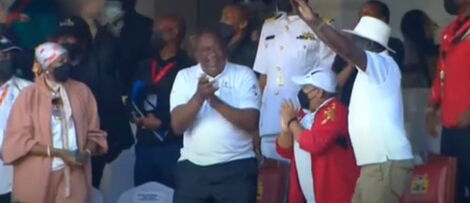 President Uhuru Kenyatta (centre), Azimio Presidential candidate Raila Odinga (right) and Sports CS Amina Mohammed (left) celebrate Ferdinand Omanyala's victory at the Kip Keino Classics at Kasarani Stadium on Saturday, May 7, 2022