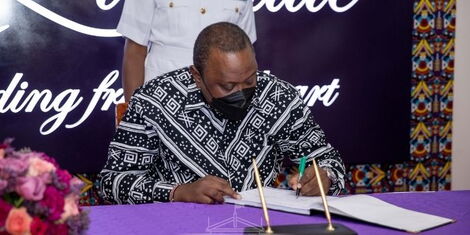 President Uhuru Kenyatta signs the visitor's book at the Kenya School of Government on Tuesday, March 8, 2022.