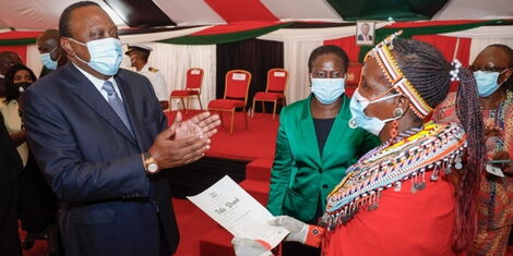 President Uhuru Kenyatta issuing title deeds at the Kenyatta International Convention Centre