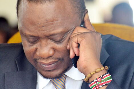 File image of President Uhuru Kenyatta on a phone call