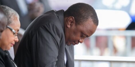 President Uhuru Kenyatta bows in prayer during a past ceremony