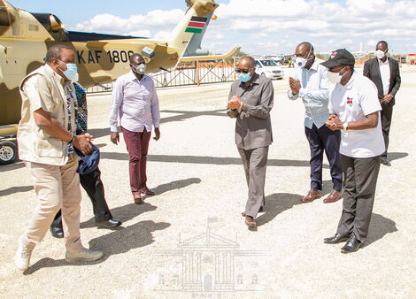 President Uhuru Kenyatta is received by National Security Advisory Committee members as Deputy President William Ruto looks on at the KWS Law Enforcement Academy in Manyani, Taita Taveta County on October 16, 2020