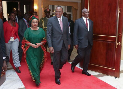 President Uhuru Kenyatta walks down the red carpet with Margaret Kenyatta.