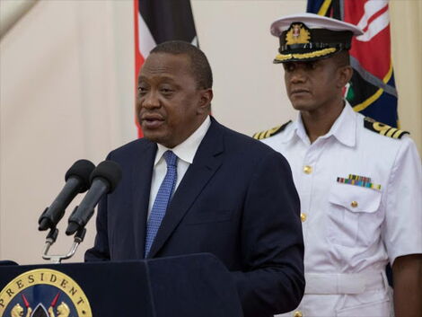 File image of President Uhuru Kenyatta with his personal aide Timothy Lekol