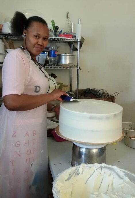 Undated photo of Katerina Murigi decorating a cake