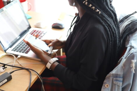 A file image of a woman using a phone.