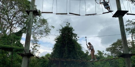 An undated image of someone taking the high ropes challenge.