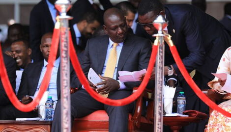 President William Ruto receiving a notice from his aide at during his inauguration ceremony at Kasarani on Tuesday, September 13, 2022