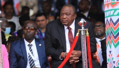 Former President Uhuru Kenyatta listens on as President William Ruto reads his speech at Kasarani Stadium on Tuesday, September 13, 2022