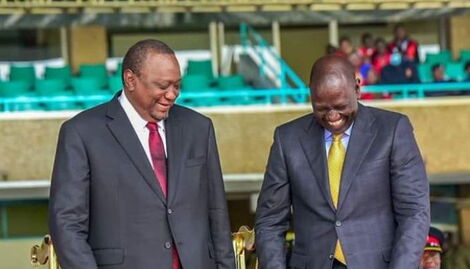 Former President Uhuru Kenyatta sharing a light moment with President William Ruto at Kasarani Stadium on Tuesday, September 13, 2022