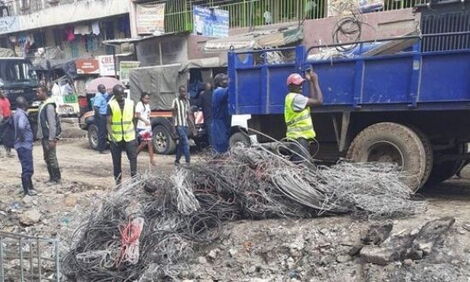 Kenya Power security personel cut off illegal power lines at Embakasi East's Tassia Estate on Thursday, February 27, 2020.