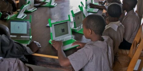 A file image of Kenyan students using laptops in a classroom.