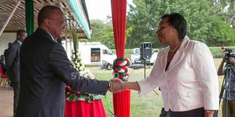 Former President Uhuru Kenyatta congratulates Prof. Margaret Kobia after she was sworn-in as Cabinet Secretary, Public Service, Youth and Gender Affairs, at State House, Nairobi in 2018