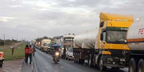 An image of trucks plying a Kenyan highway