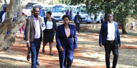 Machakos Governor Ndeti (centre) takes a stroll during a past political event accompanied by her aides. 