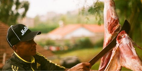 A file image of a man slaughtering a goat