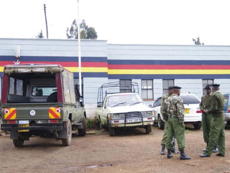 An image of vehicles parked outside a police station