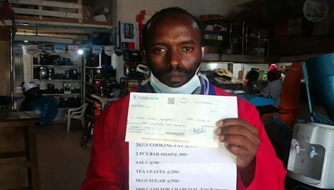 Wanjohi Ndungu poses for a photo with the cheque addressed to the president on Apil 4, 2020.