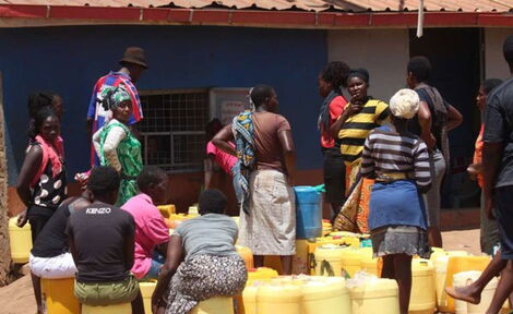 File photo of residents lining up to get water