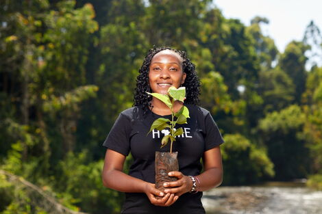 File photo of climate activist Elizabeth Wathuti holding a seedling.