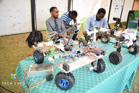 "The Knights" from JKUAT university pose with their invention- an A.I guided bot that uses technology in eliminating weeds on a farm.