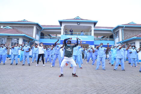 A dance instructor takes the health workers at Mbagathi isolation centre through a dance routine on May 28, 2020.