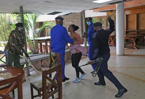 Police officers clobber Mlango Kubwa MCA Patricia Mutheu at City Hall on Tuesday, July 28.