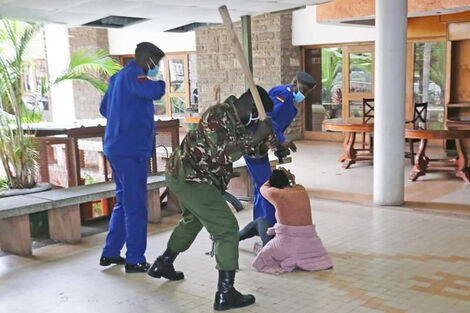 Police officers clobber Mlango Kubwa MCA Patricia Mutheu at City Hall on Tuesday, July 28.