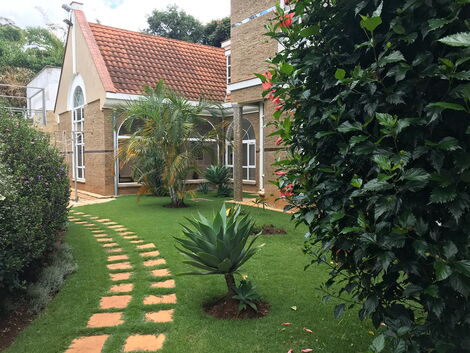 Well manicured lawn leading to the gate of the Ksh750 million Muthaiga Mansion.