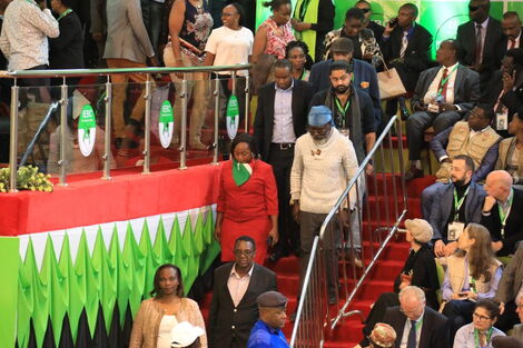 Roots Presidential Candidate George Wajackoyah with a durag and his deputy Justina Wamae in red at Bomas of Kenya on August 15, 2022