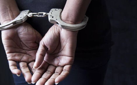 A woman in handcuffs