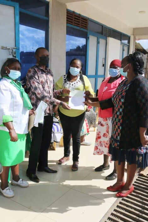 MP Kuria Kimani issuing a Women Empowerment Fund cheque to residents s onApril 18, 2021