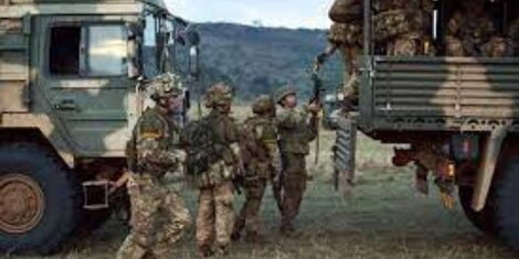 Soldiers climb into a military truck during a simulated military exercise of the British Army Training Unit in Kenya 