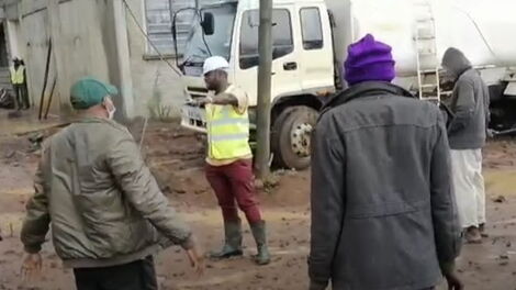 The businessmen confronts workers at the construction site.